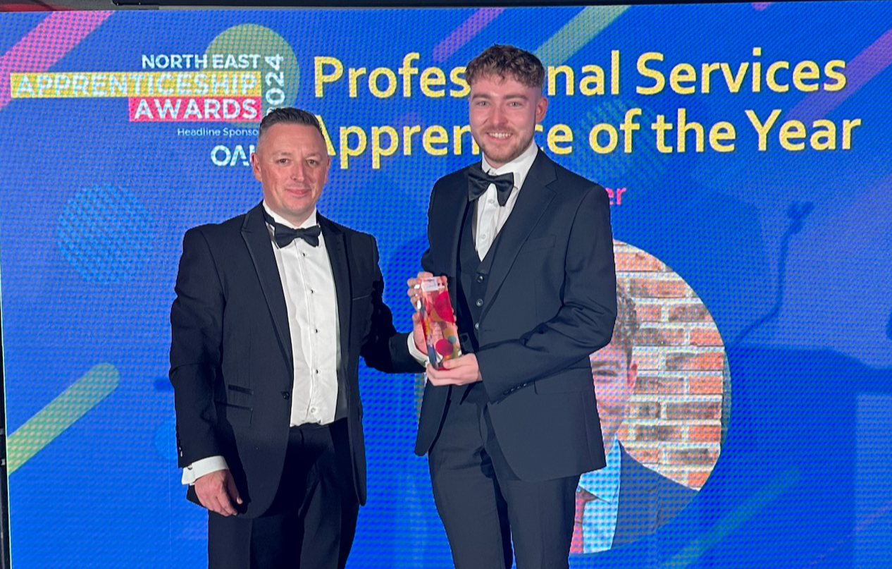 Ben receiving his award on stage for Professional Services Apprentice of the Year 2024