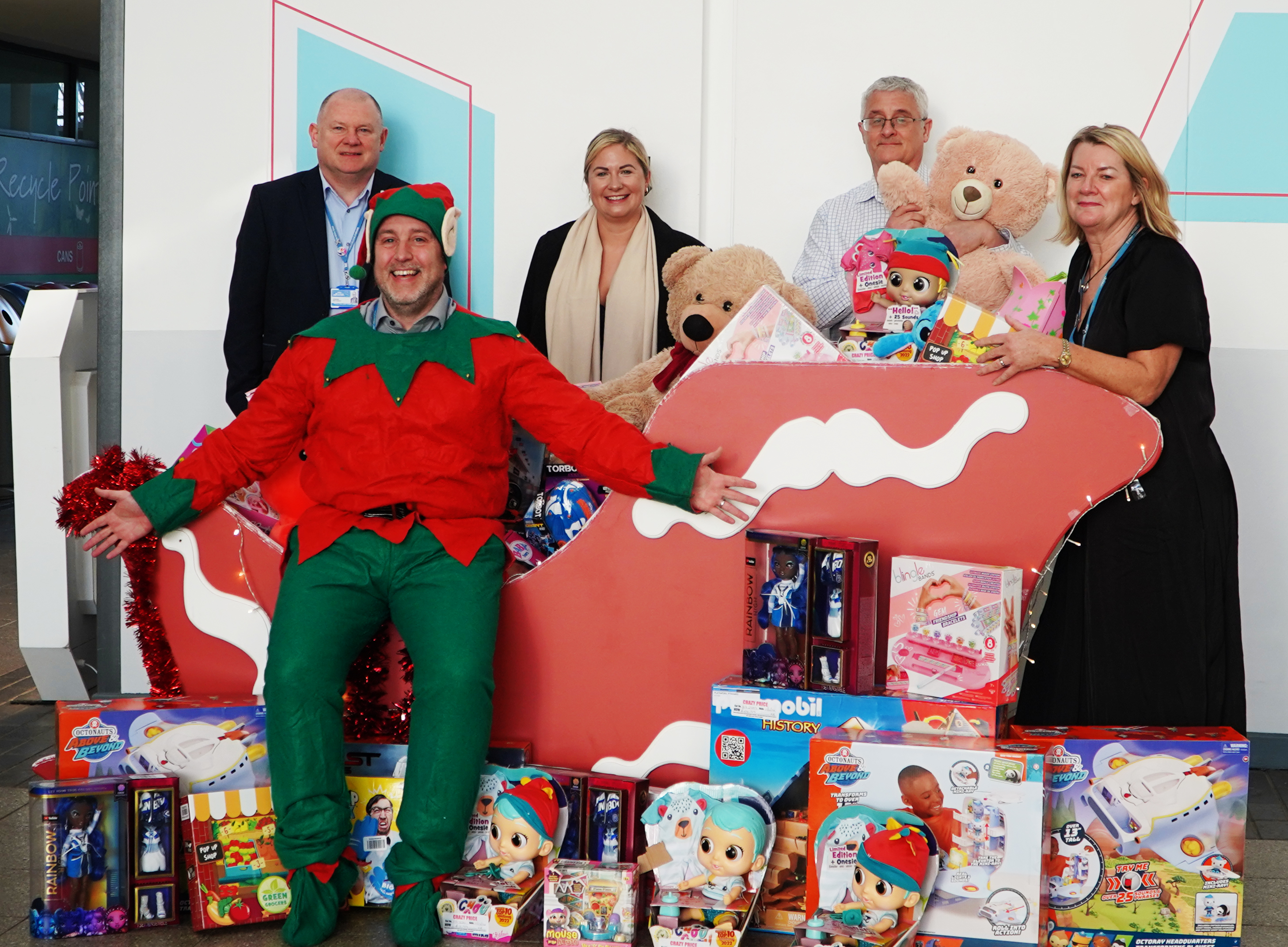 Senior leadership with sleigh full of presents